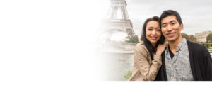 Business Loan image: A young smiling Asian couple on vacation in Paris France